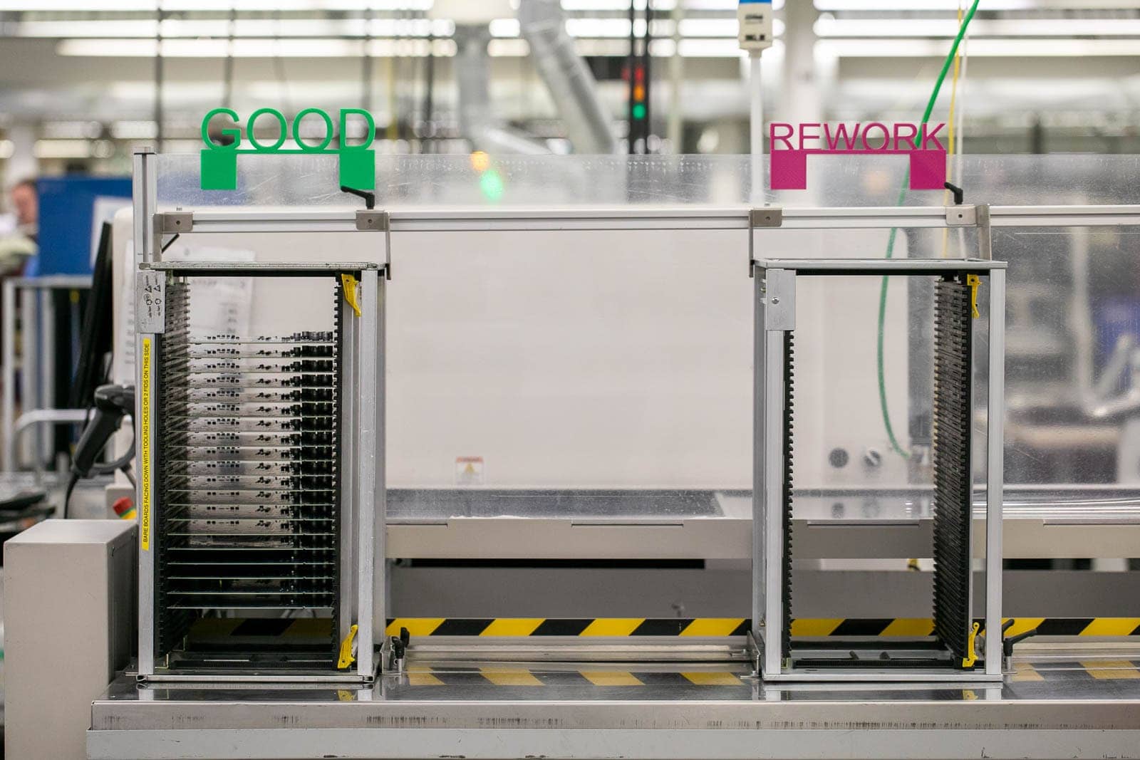 The end of an SMT line at RIS showing the auto-sorting system of good and rework boards. This automated system saves time and adds efficiency to our SMT process. It also means that workers don't need to physically touch any of the boards while transporting them to the next part of the process.