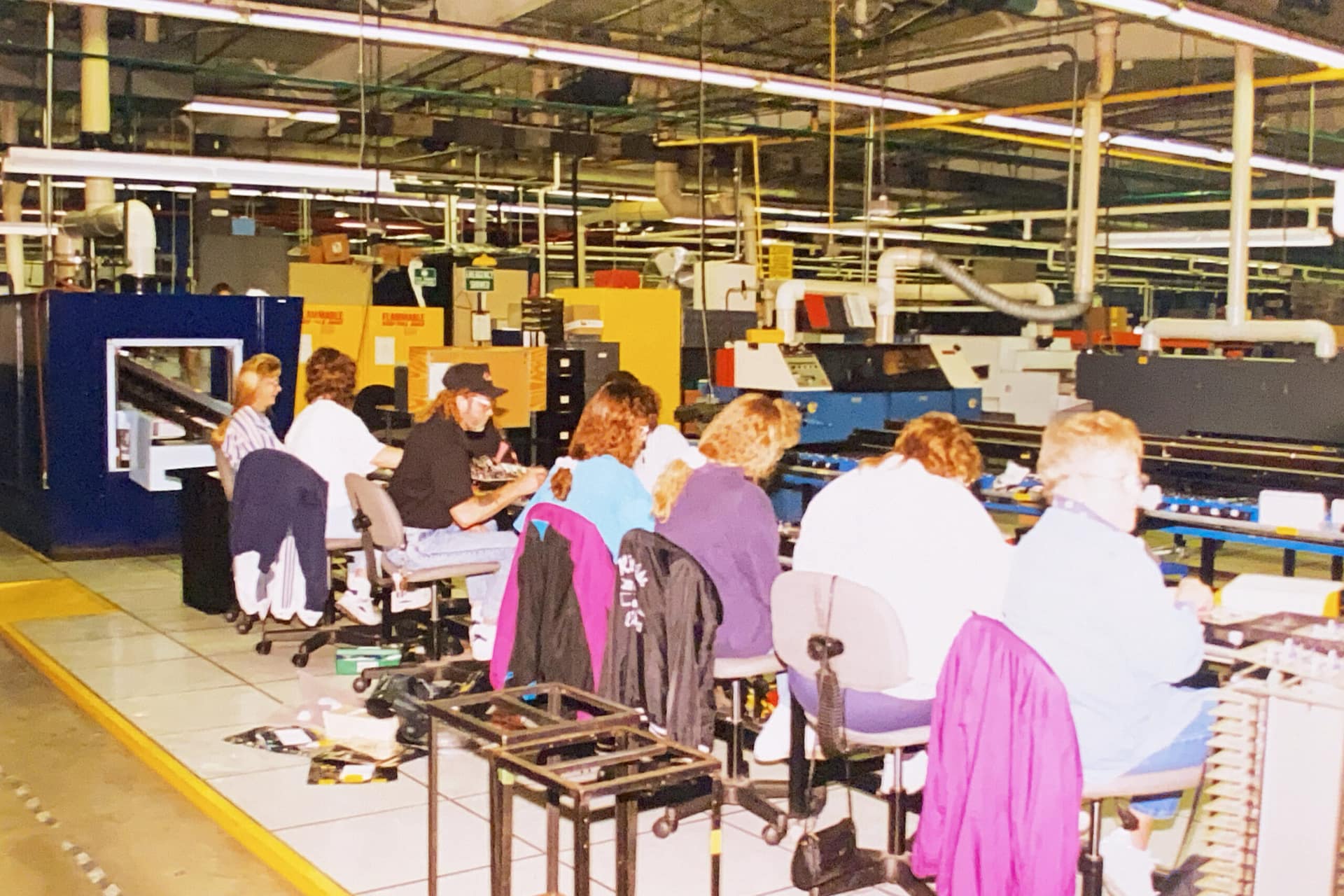 The original RiverSide workers in 1984, hand assembling and soldering PCBAs in a traditional assembly line.